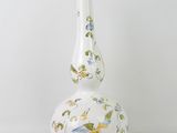 a white vase with a bird design on it