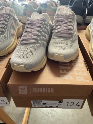 several pairs of running shoes are on display in a shoe store