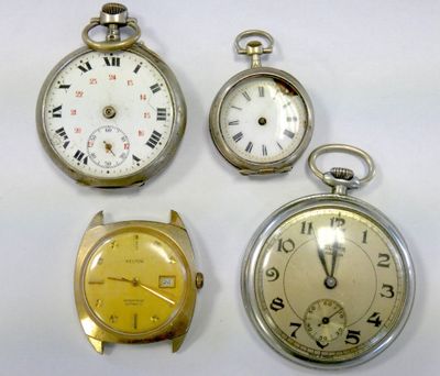 three different types of pocket watches are displayed on a white surface