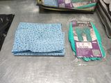 two bags of cleaning cloths and a pair of gloves on a table