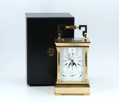 an image of a gold clock with a black box on a white background