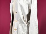 an image of a white jacket on a mannequin stand