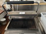 a grill that is sitting on a counter in a kitchen