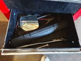 a box with tools inside of it on the floor