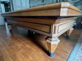 a large wooden table on a hard wood floor