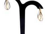 a close up of a pair of earrings on a black stand