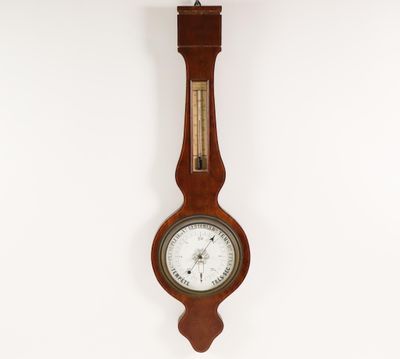 clock hanging on the wall in a room with a white wall