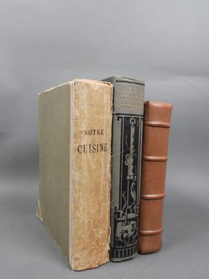 two books sitting on top of each other on a gray surface
