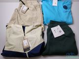 three pairs of men ' s pants and a t - shirt on a table