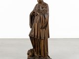an old bronze statue of a man with a dog on a pedestal