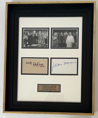 une image représentant une photo encadrée d'un groupe de personnes, sur laquelle figurent des autographes
