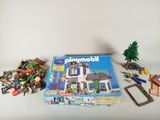 a box of playmobil with a bunch of toys on the table