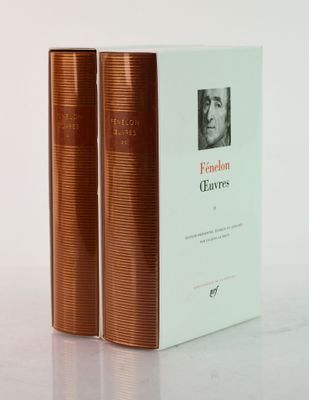 two books sitting on top of a white table next to each other