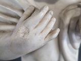 a statue of a child holding a bird in his hands