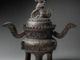 an image of a bronze teapot with a dragon on top