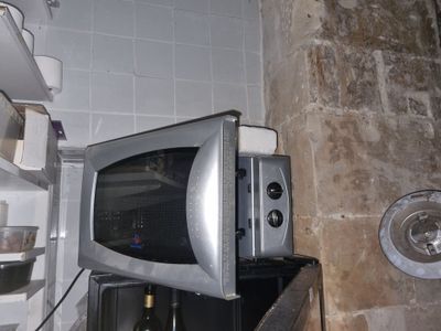un micro-ondes posé sur un réfrigérateur dans une cuisine