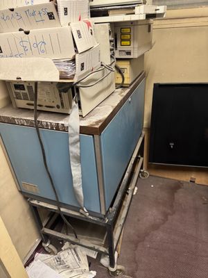 a pile of boxes on top of a cart in a room