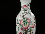 a white vase with a painting of flowers and birds on it