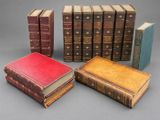 several old books sitting on top of each other on a table