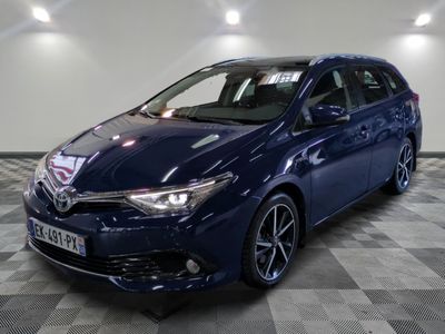 the blue toyota auris is parked on a checkered floor