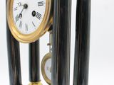 a black and gold clock sitting on top of a table