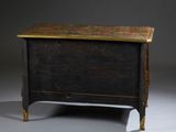 a small chest with a wooden top on a grey surface