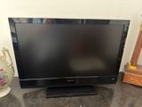 a black flat screen tv sitting on top of a counter