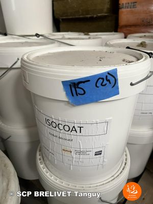 several buckets of paint are stacked on top of each other in a warehouse