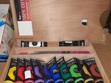 a wooden box filled with assorted items on a table