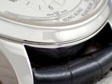 a close up of a watch with a black leather band