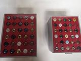 two boxes that have buttons in them on a table