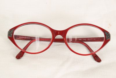 a pair of red glasses on a white surface