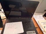 a laptop computer sitting on top of a wooden desk