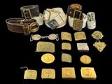 some gold and silver items are arranged on a black surface
