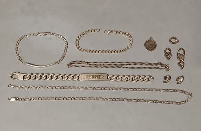 an assortment of silver jewelry including a bracelet, bracelet, and ring
