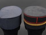 two military hats sitting next to each other on top of a table