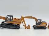 three toy construction vehicles that are on a white surface