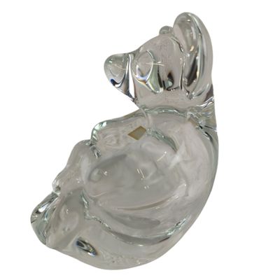 a glass figurine of a woman with a hat on her head