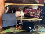 many bags and purses on a shelf in a room