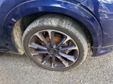 a blue car that has a flat tire on it