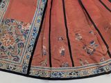 a red skirt with a blue and gold pattern on it