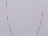 a silver necklace with a square shaped pendant on a chain