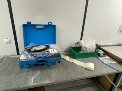 an image of a table with a blue case and a pair of scissors on it
