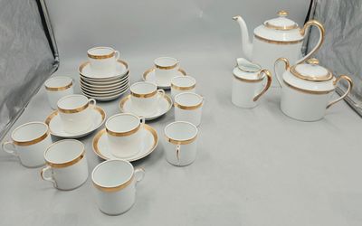 a lot of cups and saucers sitting on a table