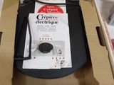 a cardboard box with a black electronic device inside of it