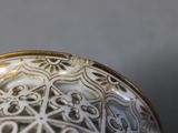 a close up of a decorative bowl on a table