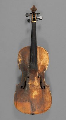a close up of a violin on a gray surface