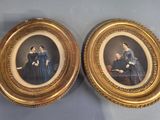 Deux portraits encadrés représentant des femmes en robe bleue sont posés sur une table.