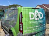a green van that is parked in the yard