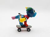 a small figurine of a duck on a skateboard